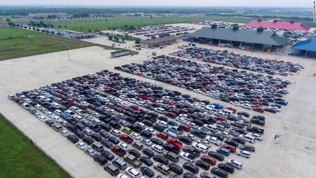 People wait in their cars for the San Antonio Food Bank to begin food distribution on April 9.